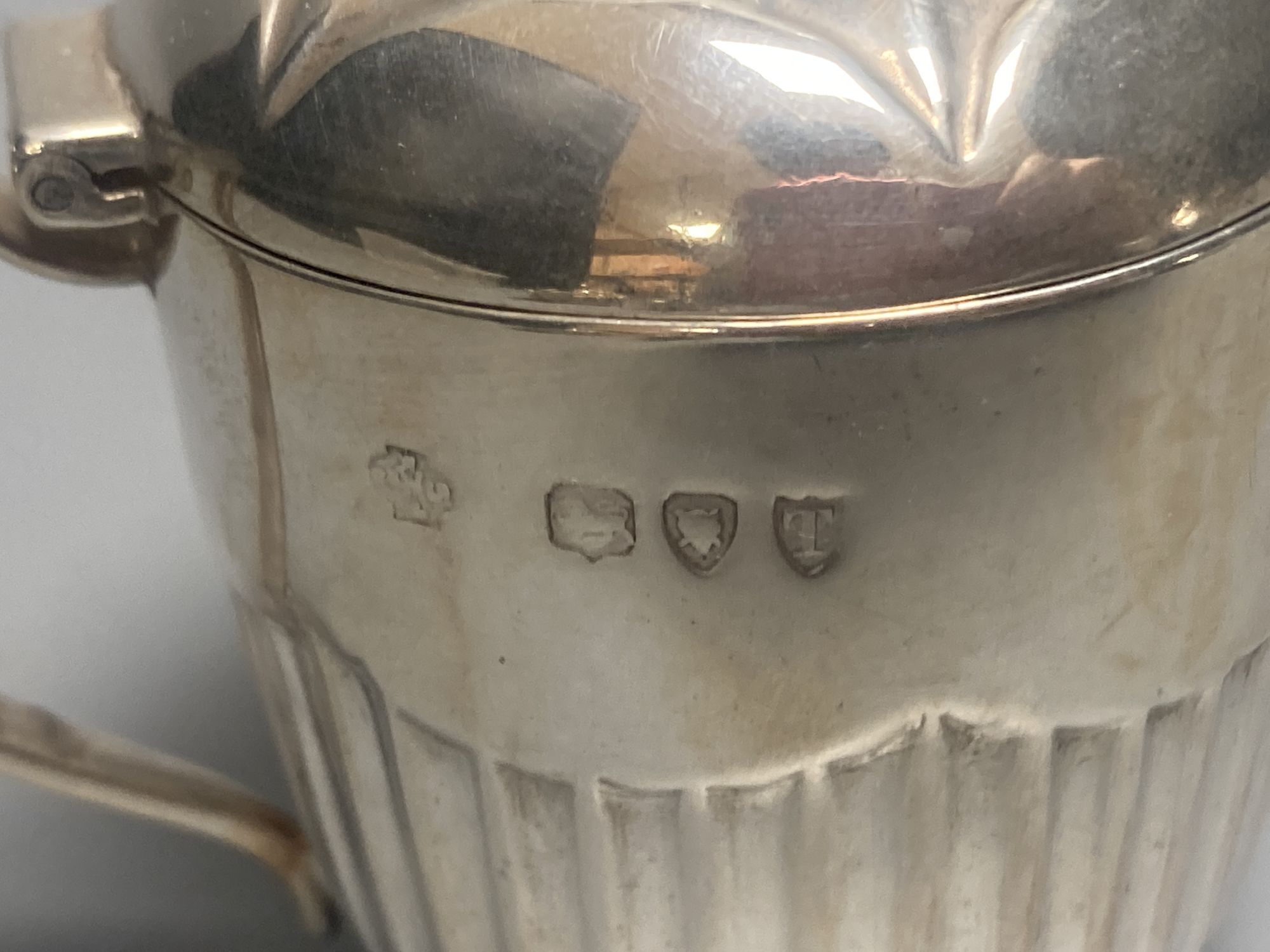 A late Victorian demi fluted silver mustard pot, London, 1894 and four other assorted later silver mustards.